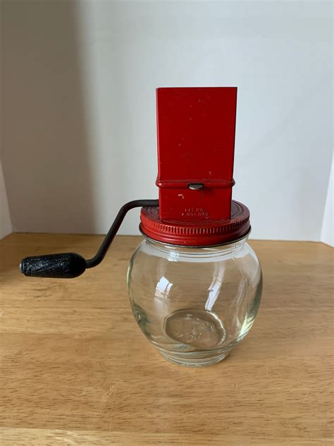 Vintage Nut Meat Chopper. 5 1/2" tall. Freely cranks. No chips or cracks in the glass jar.